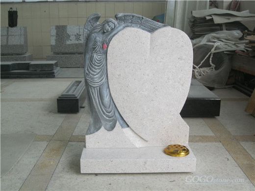 White marble headstone with heart shape and angel