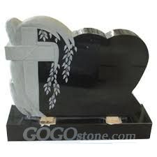 Black granite headstone with tree carving