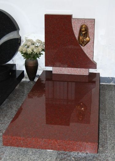 Red granite gravestone with slab