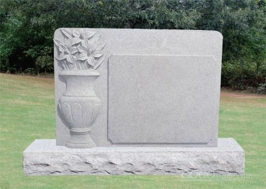 white marble gravestone with flowerpot carved